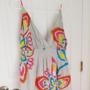 Vibrant tropical floral sundress on pale gray